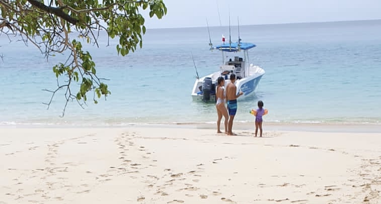 Sean Ali's family on a beach boat during a travel and lifestyle freedom moment